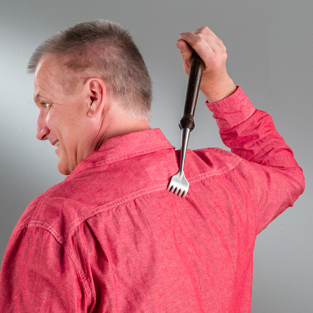 A man using the Rockler Stainless Steel Back Scratcher to scratch his back - main pic