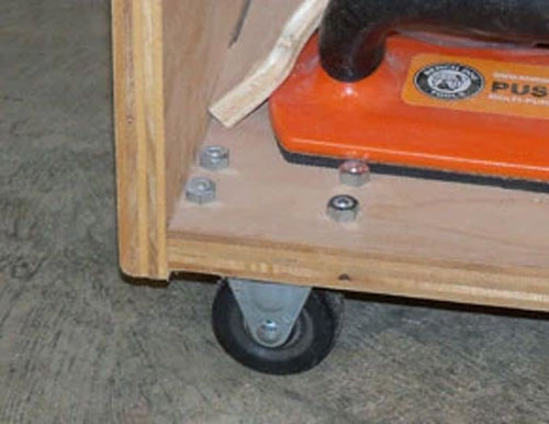 Caster installed on corner of shop cabinet