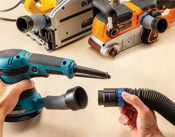 Click-connect hose fitting attaching to sander