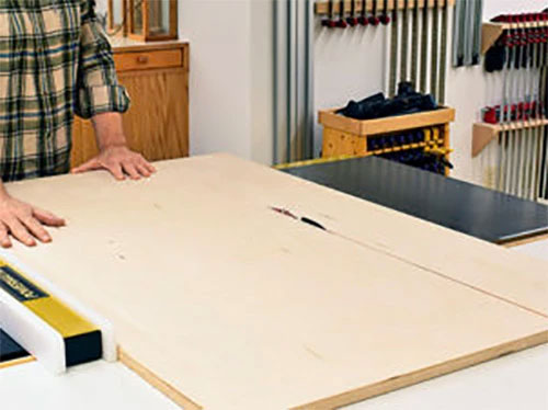 Sawing large plywood panel with melamine cutting blade