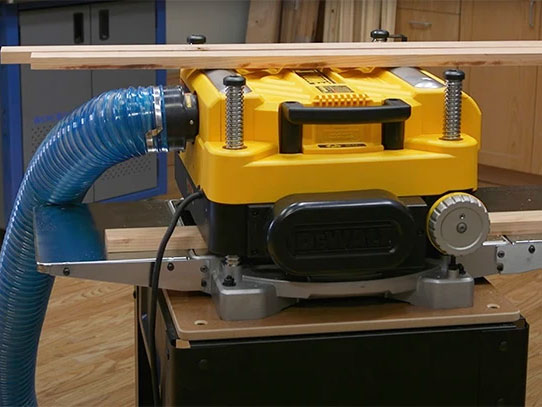 Demonstration of planed board and board running through DeWalt Planer