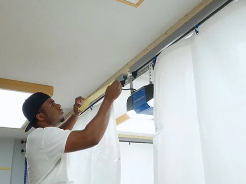 installing ceiling tracks for paint booth