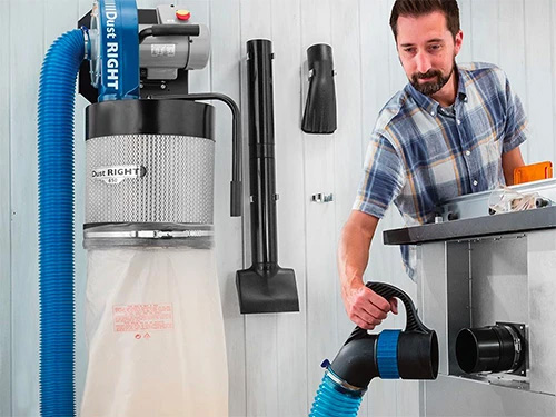 Vacuuming in a small workshop with a dust right wall-mouinted dust collector