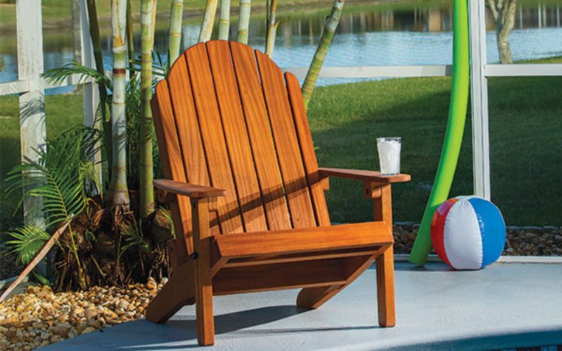 finished adirondack chair on patio near water
