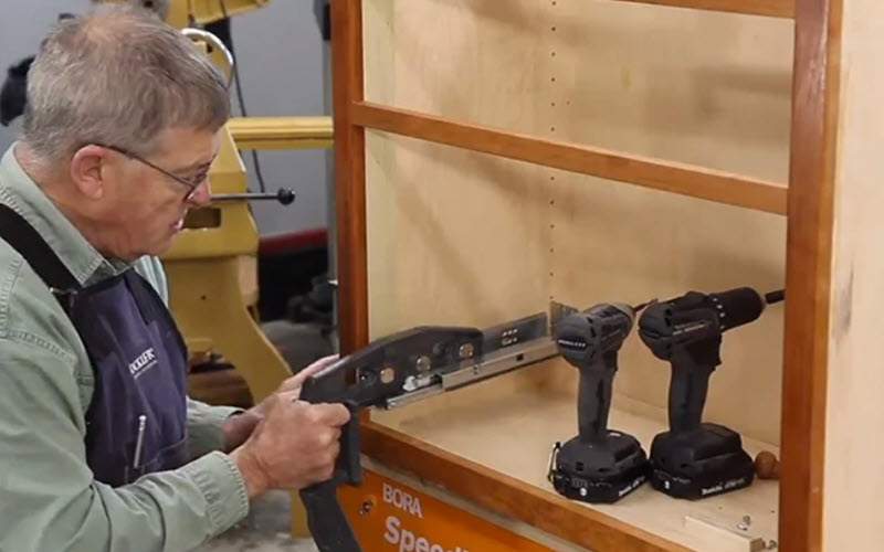 man installing drawer slides