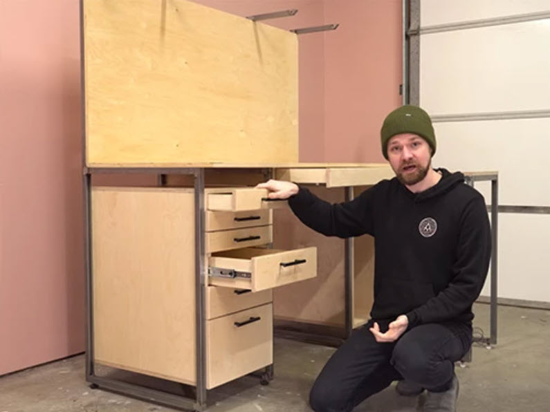 man kneeling next to cabinet build project