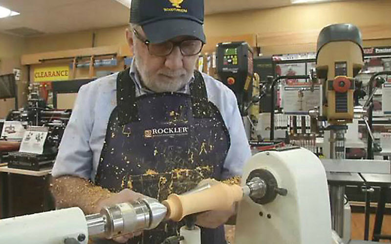 man working on lathe