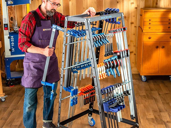 Man placing wood clamp on pack rack cart