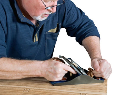 Flattening a piece of lumber using a smoothing plane