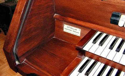 Red stained wood piano turning Brown