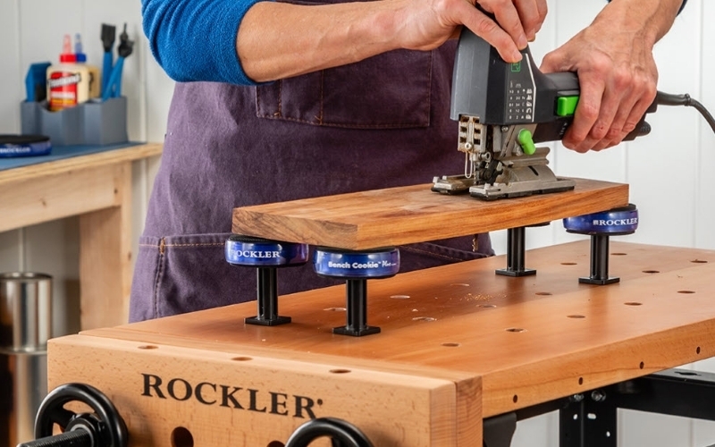 man using jigsaw on wood piece elevated by rockler bench cookies