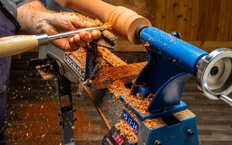 person turning project on wood lathe