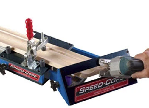 Trimming crown molding with a jig guide