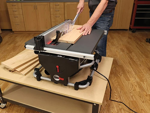 Running lumber across compact sawstop saw