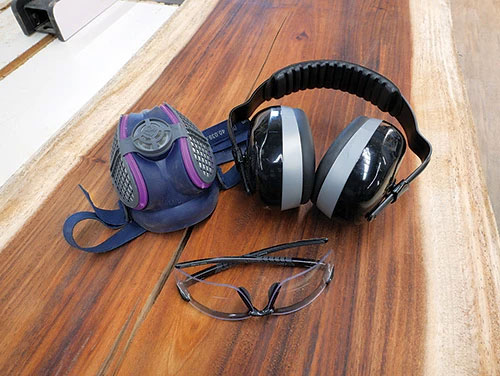 Safety equipment for band saw including a respirator, over-ear hearing protection and eye glasses
