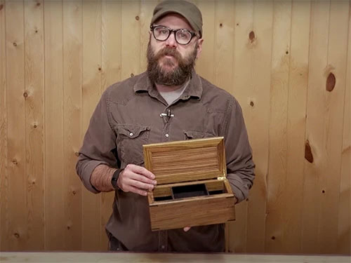 Keepsake box with sliding trays and a hidden compartment