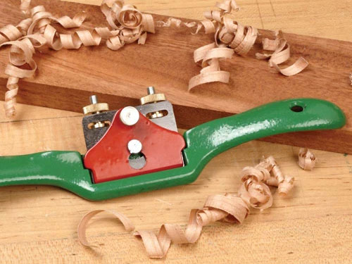 Spokeshave laying on a piece of lumber