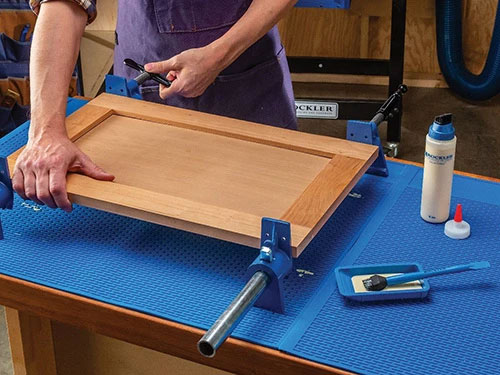 Clamping frame and panel door with sure-foot pipe clamps