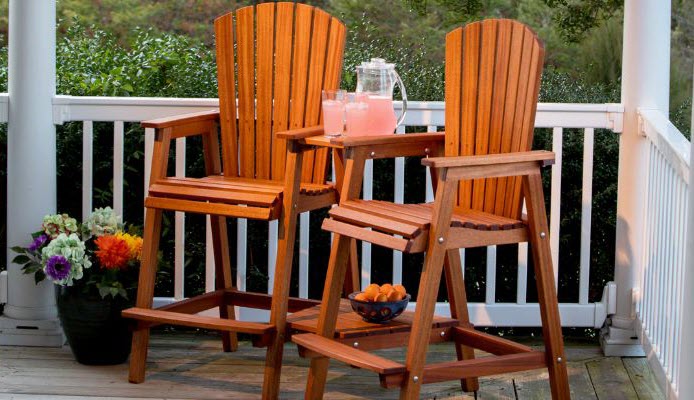 Two bar height adirondack chairs on outdoor patio