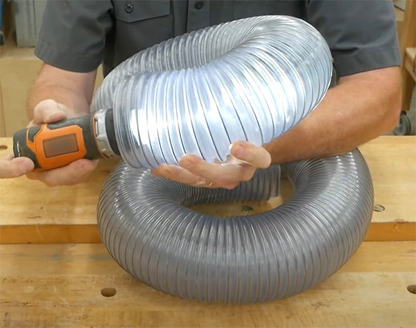 flashlight shining in 4-in dust hose