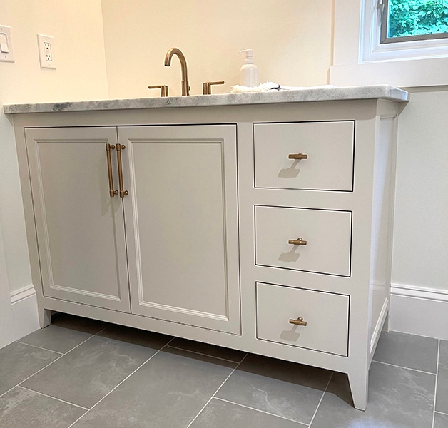 painted white bathroom vanity with three drawers