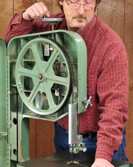 Using wheel to adjust the tension on a band saw blade