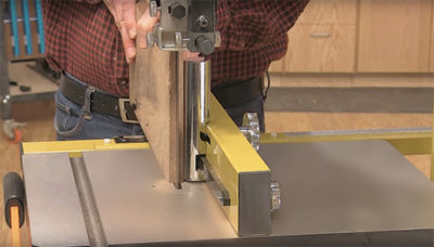 Cutting with a band saw along a rip fence
