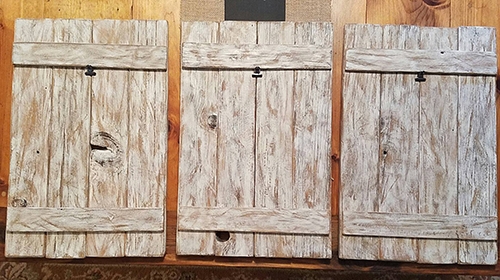 three unfinished panels of old barnwood