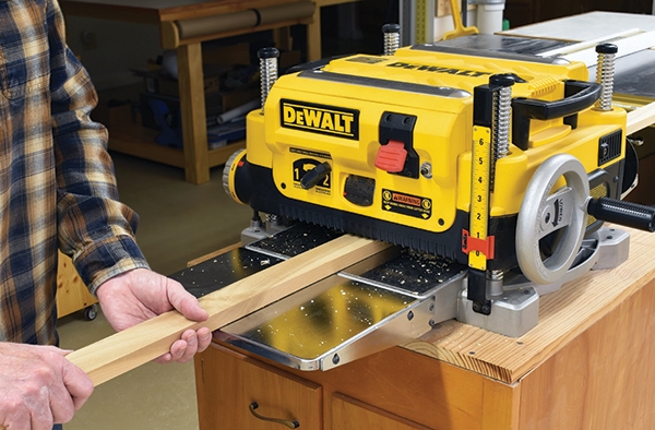 feeding lumber into benchtop planer