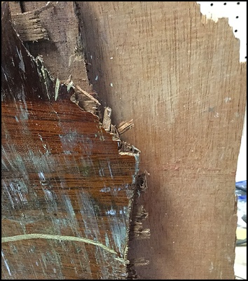 Close-up of splintered plywood sailboat centerboard