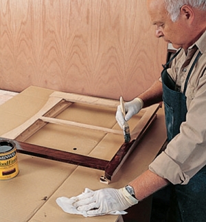Using a brush to wipe on a dark minwax stain