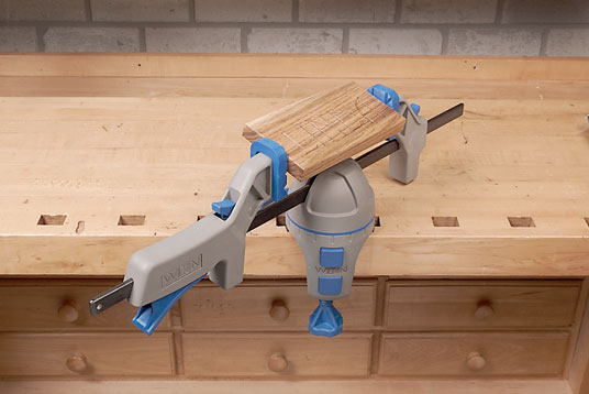 Stock for carving sign letters clamped to a workbench