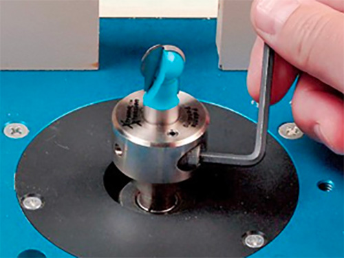 Using a hex wrench to change the collet on a router