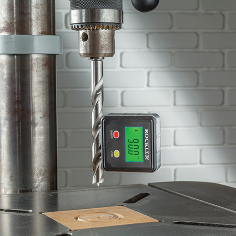 Level box attached to bit on drill press