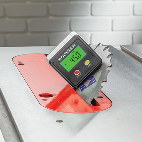 Level box attached to table saw blade with magnets