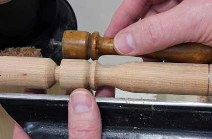 Checking newly turned spindle against original piece