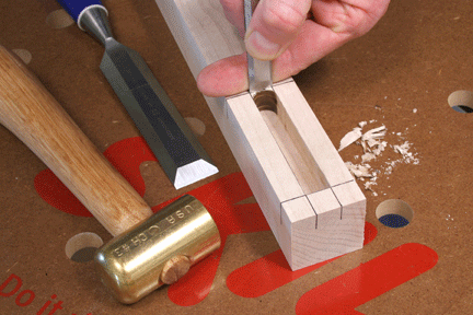 Chiseling out the last piece of a completed mortise