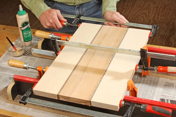 Applying Titebond III glue and clamping cutting board sections together