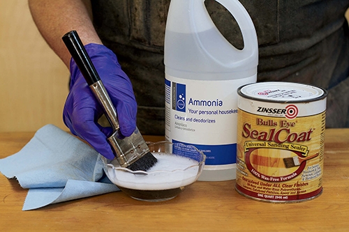 Cleaning finishing brushes with sudsy ammonia