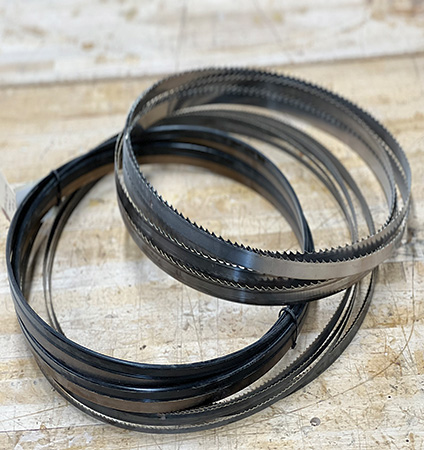 Collection of three coiled band saw blades