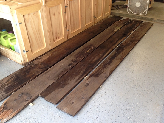 Laying out antique wood planks on a shop floor for color and grain matching