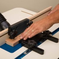 Using featherboards to guide coping sled cut