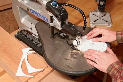 Cutting out box lid by tracing around template with a paper template