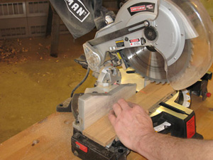 Using miter saw to cut white oak pieces for napkin holder