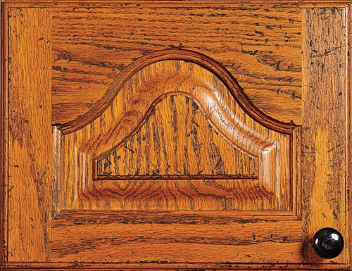 Cabinet door panel with a pre-distressed finish