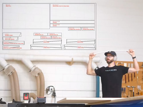 Chris Salomone sizing parts for a desk project according to plan diagram