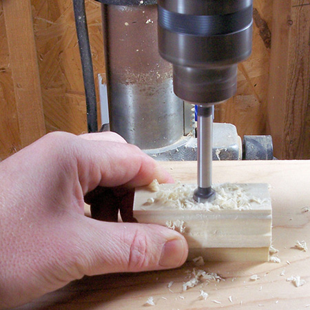 Drilling out hole to place router bit shaft