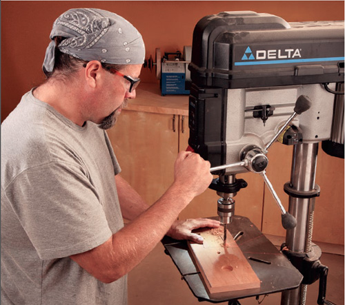 man using a drill press