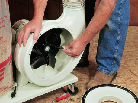 man checking the fans of a dust collector