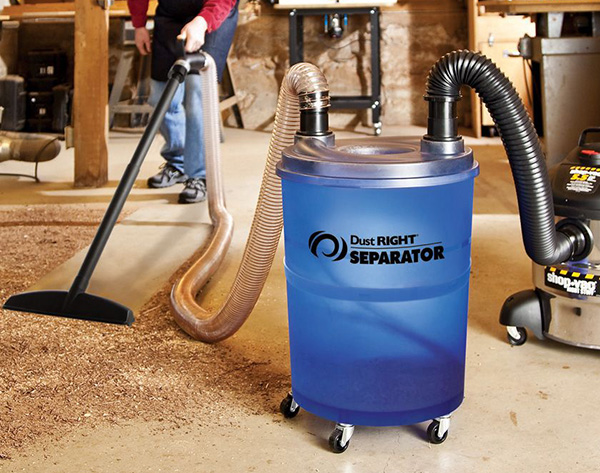 man vacuuming shop with dust right dust separator